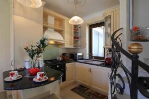 a kitchen with a counter with two cups on it at Le Petit Palais Villa in Plesio