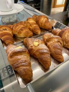 a bunch of croissants on a display case in a bakery at Casa Nostra in Selva del Montello