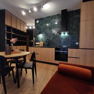 eine Küche mit einem Tisch und einem Esszimmer in der Unterkunft Apartamenty Białystok - Apartment Royal VI in Białystok