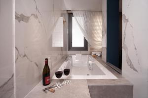 a bathroom with a tub with two glasses of wine at Berjer Boutique Hotel & Spa in Istanbul