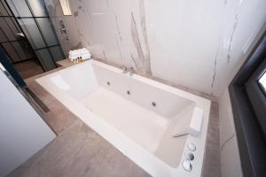 a white bath tub in a bathroom with a shower at Berjer Boutique Hotel & Spa in Istanbul