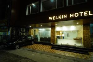 a car parked outside of a wellini hotel at night at Welkin Hotel in Secunderabad