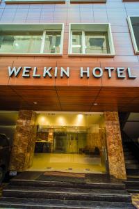 a building with the entrance to a welllit hotel at Welkin Hotel in Secunderabad