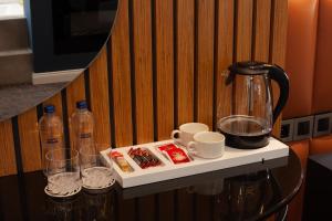 a table with a coffee maker and glasses on it at Berjer Boutique Hotel & Spa in Istanbul