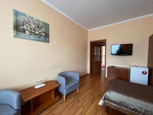 a living room with a couch and a tv at Yunist in Ivano-Frankivsk