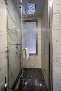 a bathroom with a shower with a glass door at Berjer Boutique Hotel & Spa in Istanbul