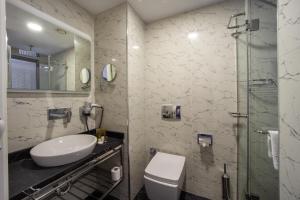 a bathroom with a sink and a toilet and a shower at Berjer Boutique Hotel & Spa in Istanbul