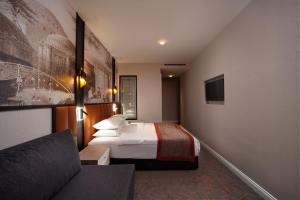 a hotel room with a bed and a couch at Berjer Boutique Hotel & Spa in Istanbul