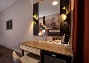 a room with a table with a microwave and a mirror at Berjer Boutique Hotel & Spa in Istanbul