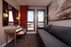 a room with a couch and a desk and a window at Berjer Boutique Hotel & Spa in Istanbul
