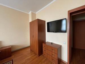 a room with a flat screen tv on a wall at Yunist in Ivano-Frankivsk