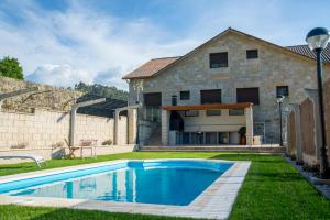 a house with a swimming pool in the yard at Welcome Villa Briallos in Portas