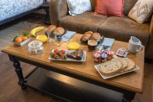 una mesa de centro con alimentos para el desayuno y bebidas. en 6 place de la détente, en Saint-Venant