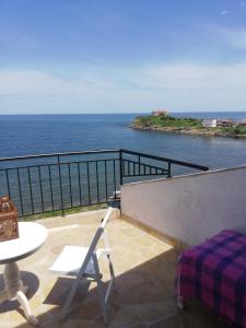a patio with a table and chairs and the ocean at Sea view apartment in Tsarevo