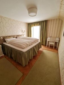 a bedroom with a large bed and a window at Villa Sukka in Winterlingen