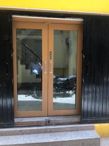 a glass door of a building with a motorcycle inside at Purple Lotus Hotel in Varanasi