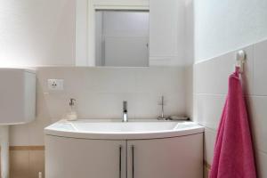 a bathroom with a sink and a pink towel at CA' DEL CORDER - A secret corner of peace in Venice