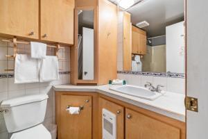 a bathroom with a toilet and a sink at Cozy Corner - Whitefoot Lodge 126 in Big White