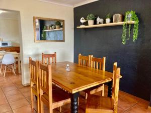 a dining room with a wooden table and chairs at Drum Rock 5 in Clarens