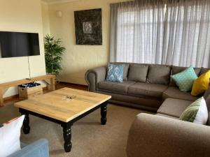 a living room with a couch and a coffee table at Drum Rock 5 in Clarens