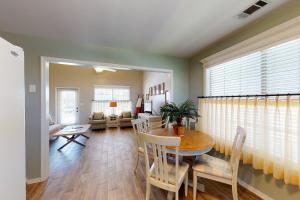 a dining room and living room with a table and chairs at 21 Palms in Gulf Shores