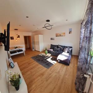 a living room with a couch and a table at Moderne Wohlfühlferienwohnung in Hildburghausen in Hildburghausen