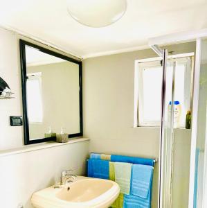 La salle de bains est pourvue d'un lavabo et d'un miroir. dans l'établissement Appartamenti Old era, à Tarente