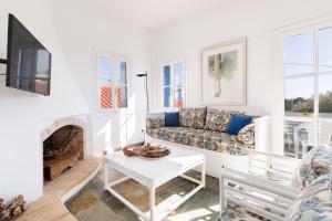 a living room with a couch and a fireplace at Aeginia 2 in Perdika