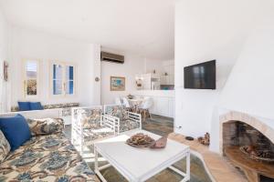 a living room with a couch and a fireplace at Aeginia Complex in Perdhika