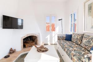 a living room with a couch and a fireplace at Aeginia 2 in Perdika