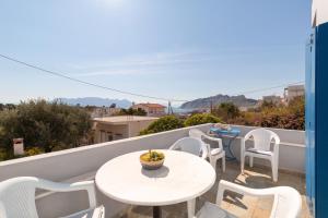 a balcony with a table and chairs and a view at Aeginia 2 in Perdika