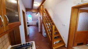 a hallway with a staircase in a house with a room at Apartma Brin Rogla in Zreče
