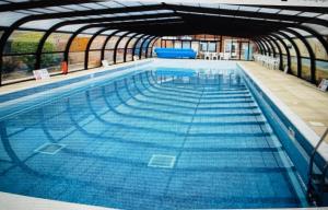 a large swimming pool with blue water at The Beach House, Suffolk Coast in Lowestoft