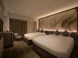 Кровать или кровати в номере ORIENTAL HOTEL UNIVERSAL CITY