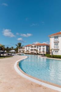 a swimming pool at a resort with condos at Hotel Palmera Bayahibe in Bayahibe