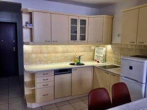 a small kitchen with white cabinets and a sink at Corso View in Budapest