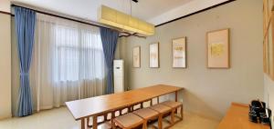 a dining room with a table and chairs and a window at Sanya Haitangwan Shang Gong Yuan She Wellness Resort Villa in Sanya