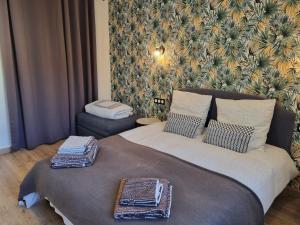 a bedroom with a bed with two pillows on it at Appartement à la campagne avec piscine in Durtal