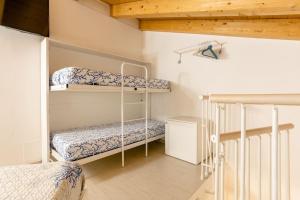 a bedroom with two bunk beds and a staircase at La Bella Vita - La Casetta in Chioggia