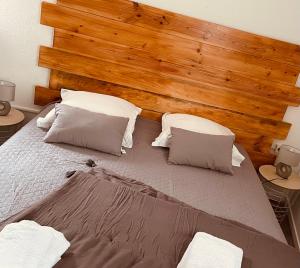 a bed with two pillows and two nightstands at Hôtel U Passa Tempu in Corte