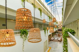 a hallway with lots of hanging lights and plants at Hotel Cabogata Jardín in Retamar