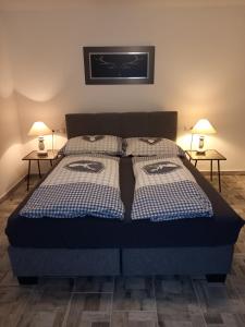 a bedroom with a bed with two side tables at Holiday Oasis Appartements in Villach