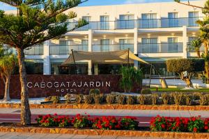 a hotel sign in front of a building at Hotel Cabogata Jardín in Retamar