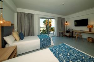 a hotel room with a bed and a living room at Hotel Cabogata Jardín in Retamar
