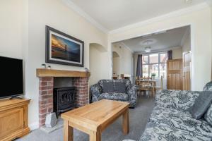 a living room with a couch and a fireplace at 14 The Promenade in Withernsea