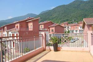 a balcony with pink houses and a mountain at Sanya Haitangwan Shang Gong Yuan She Wellness Resort Villa in Sanya