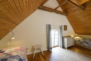 a attic bedroom with a bed and a window at Ferienhaus Remise 6 Personen mit Terrasse in Neuenkirchen