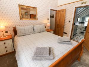 a bedroom with a large bed and a mirror at 3 Castle Orchard in Belper