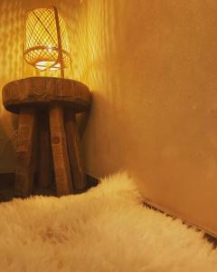 a white furry rug next to a table with a basket at La tanière Dinant in Dinant