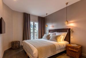 a bedroom with a large bed and a window at BE YOU LUXURY APART'HÔTEL Paris in Paris